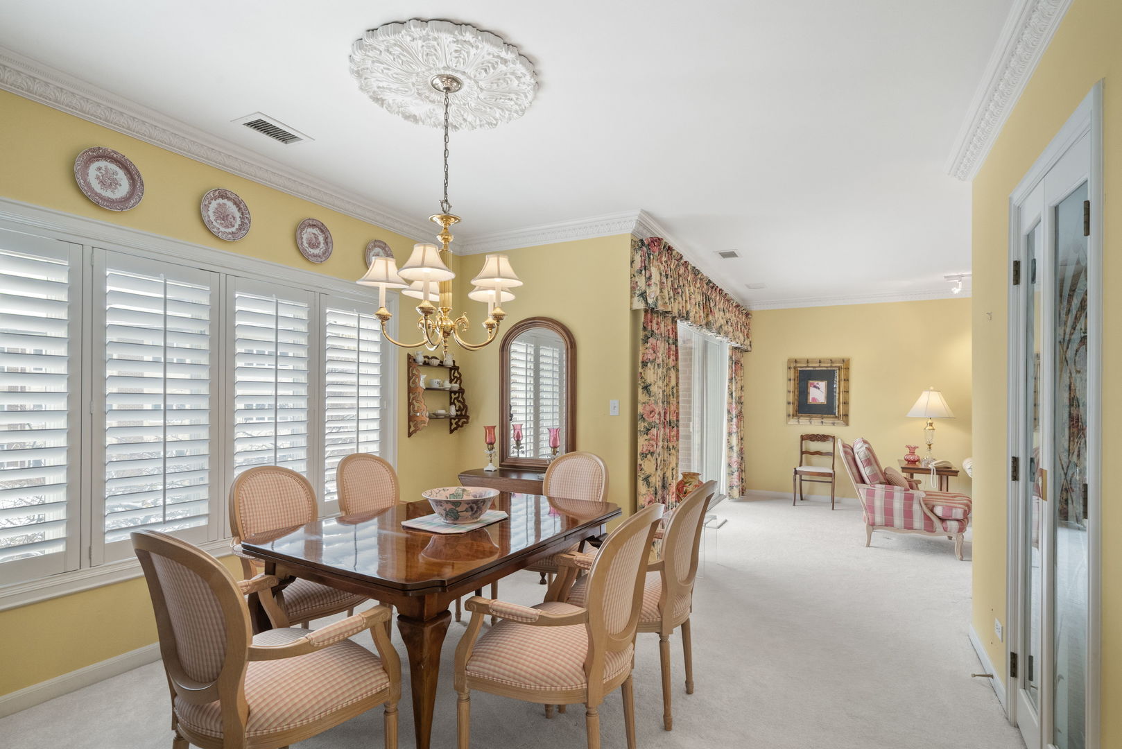3 Oak Brook Club Drive, Unit E207 Oak Brook, IL 60523 - Photo 22 of 35 a view of a dining room with furniture and chandelier