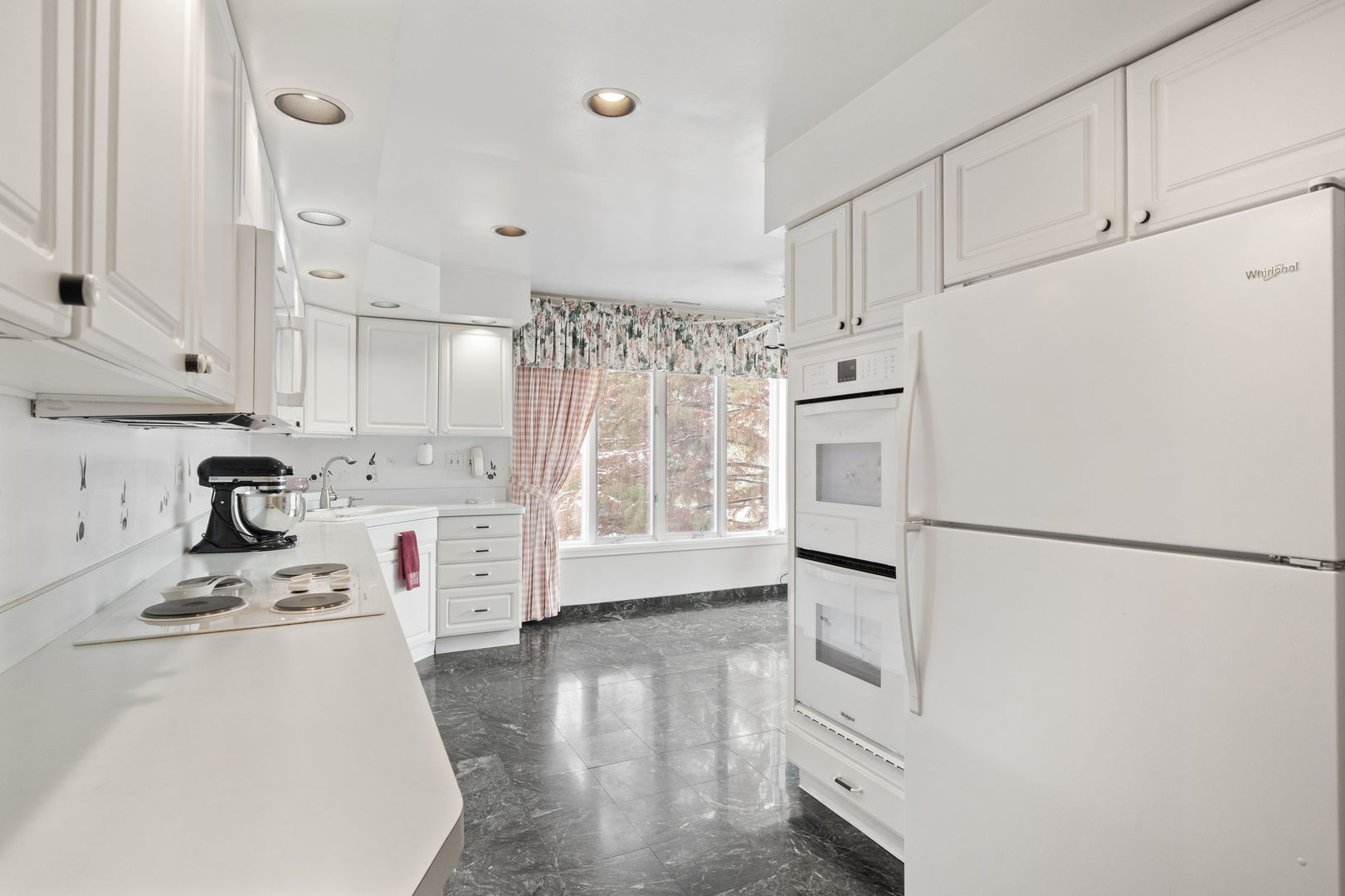 3 Oak Brook Club Drive, Unit E207 Oak Brook, IL 60523 - Photo 7 of 35 a kitchen with stainless steel appliances a refrigerator sink and white cabinets