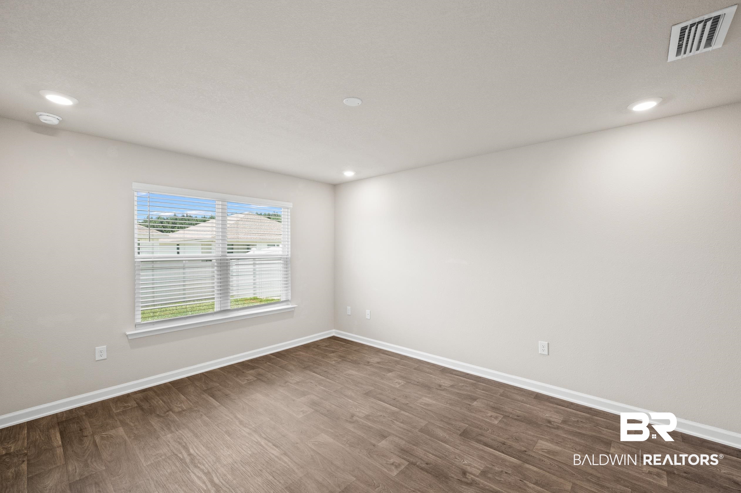 10353 Zenyatta Loop Daphne, AL 36526 - Photo 13 of 33 Spare room with dark hardwood / wood-style floors