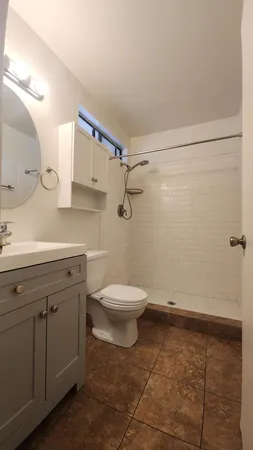 a bathroom with a toilet sink and shower