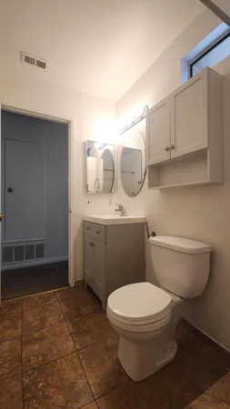 a bathroom with a toilet a sink and a shower
