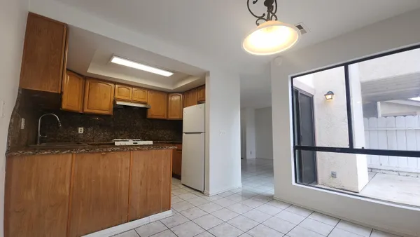 a kitchen with stainless steel appliances granite countertop a refrigerator and a sink