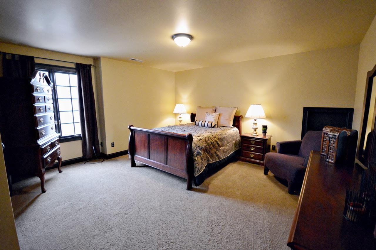 5972 Bethlehem Road Springfield, TN 37172 - Photo 23 of 29 a spacious bedroom with a bed and wooden floor
