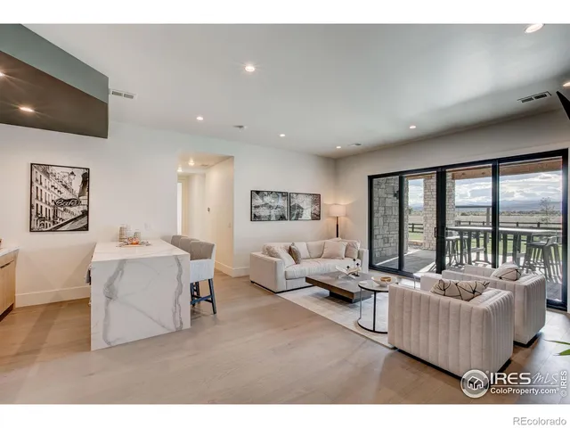 a living room with furniture and large windows
