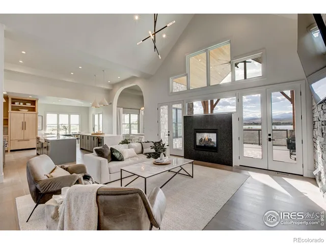 a living room with furniture a fireplace and a large window