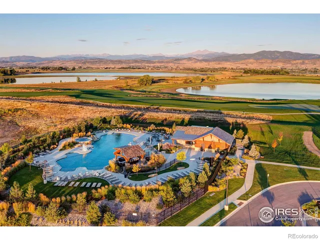 a view of a dining room with furniture and a chandelier