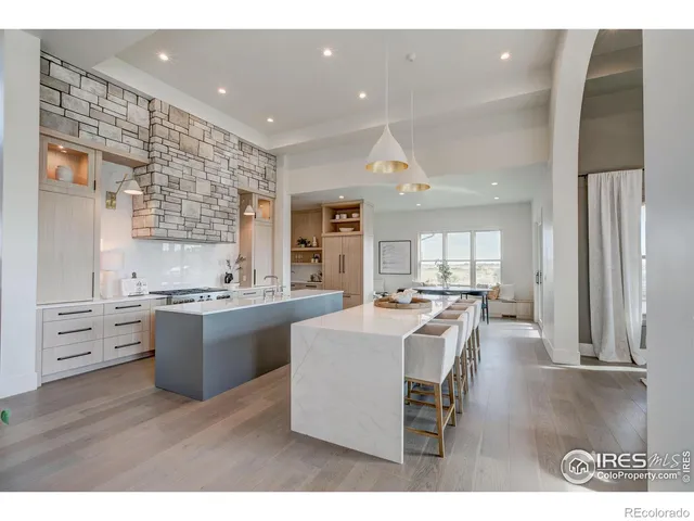 a large kitchen with kitchen island a sink stainless steel appliances and cabinets