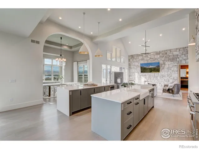 a large white kitchen with a large window