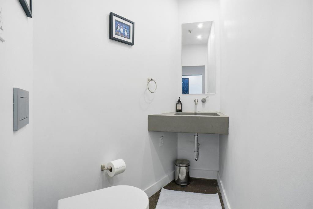 2220 Canton Street, Unit 407 Dallas, TX 75201 - Photo 11 of 39 a bathroom with a sink toilet and a mirror