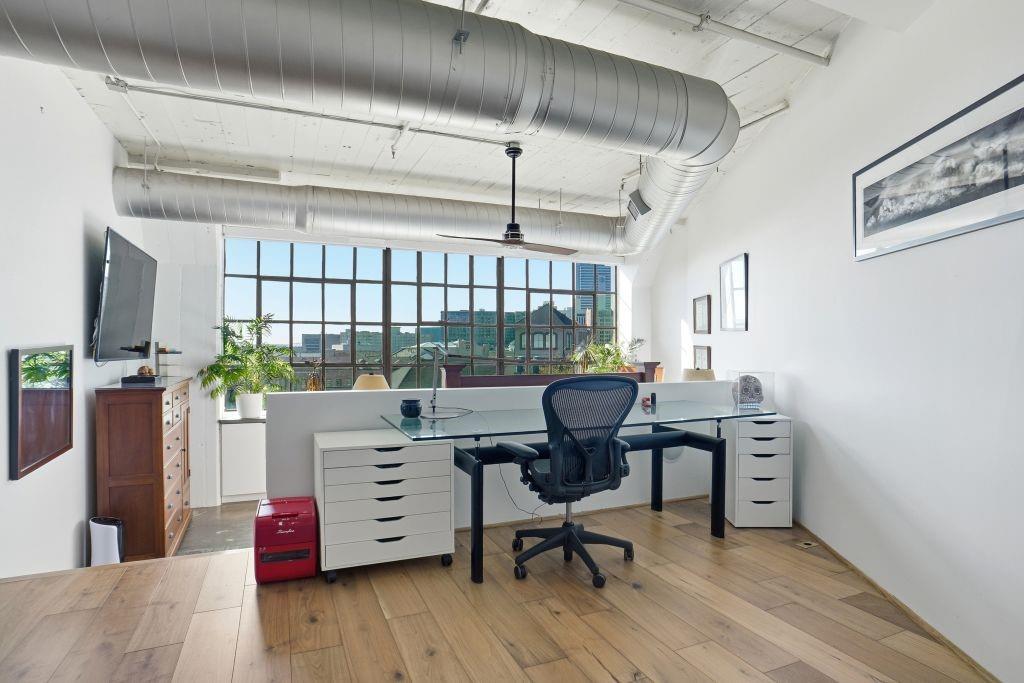 2220 Canton Street, Unit 407 Dallas, TX 75201 - Photo 18 of 39 a workspace with furniture hardwood and a window