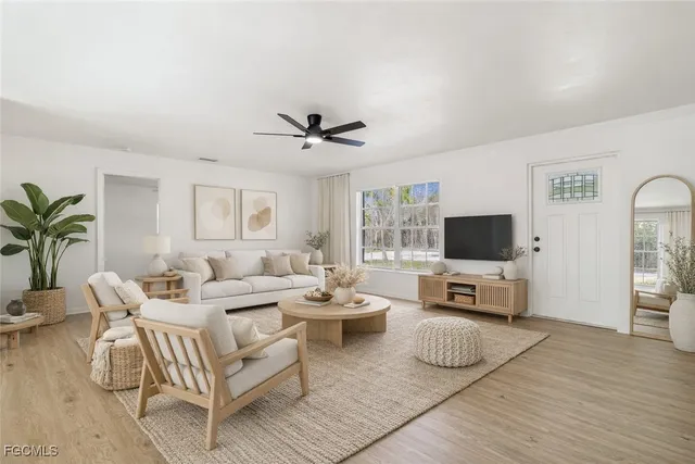 a living room with furniture a flat screen tv and a fireplace