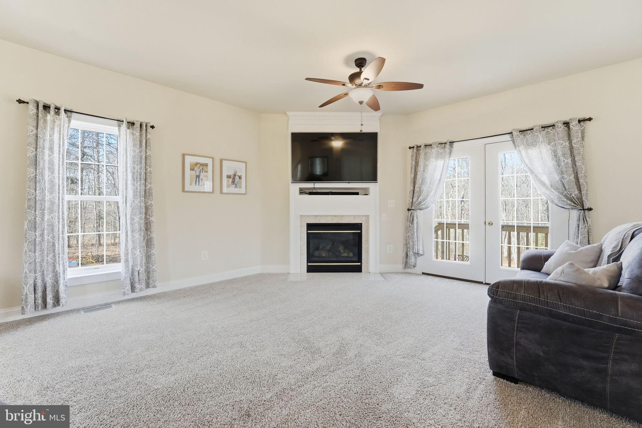 2171 Towles Road Midland, VA 22728 - Photo 17 of 58 a living room with furniture a flat screen tv and a fireplace