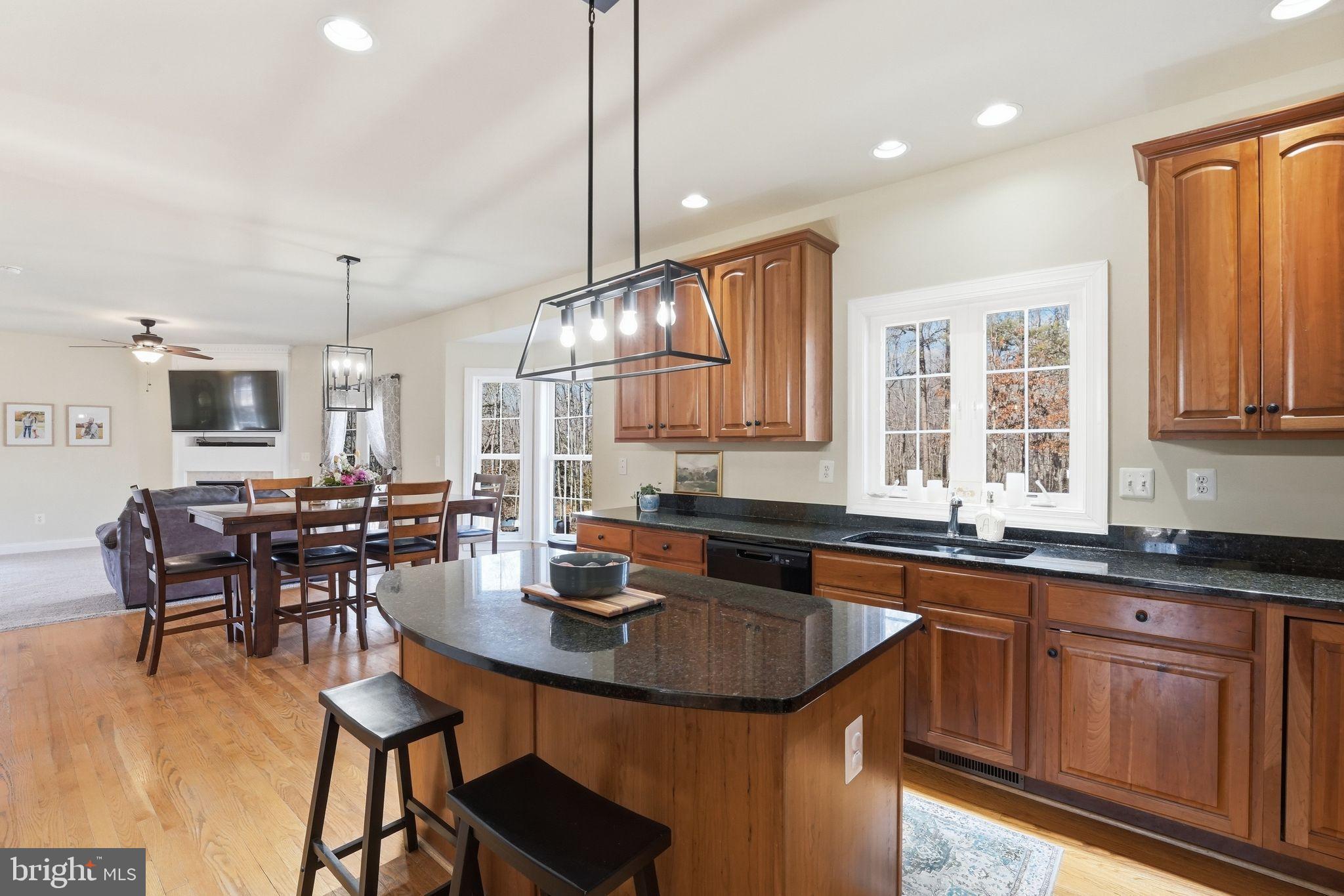 2171 Towles Road Midland, VA 22728 - Photo 23 of 58 a kitchen with granite countertop a sink a center island stainless steel appliances and cabinets