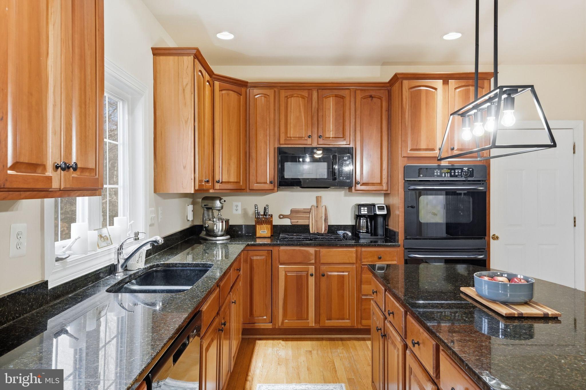 2171 Towles Road Midland, VA 22728 - Photo 24 of 58 a kitchen with stainless steel appliances granite countertop a sink a stove and a microwave