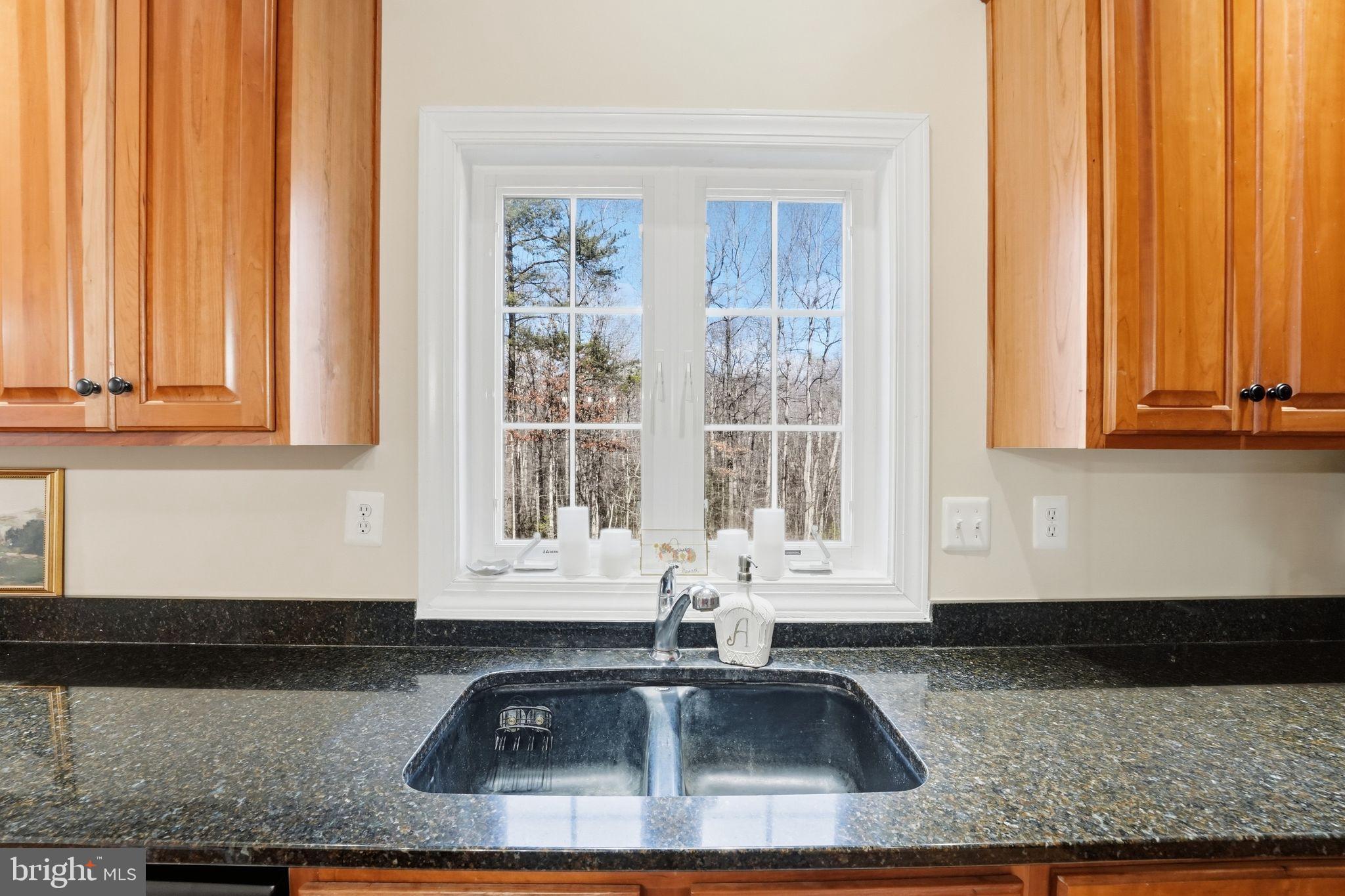 2171 Towles Road Midland, VA 22728 - Photo 25 of 58 a kitchen with granite countertop a sink and a white wooden cabinets