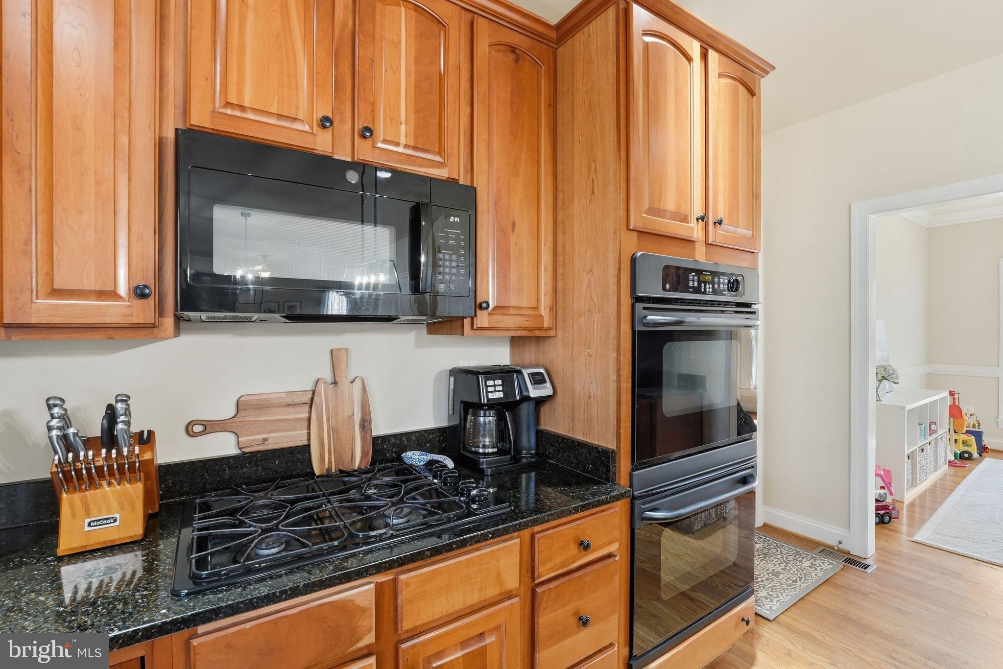 2171 Towles Road Midland, VA 22728 - Photo 26 of 58 a kitchen with stainless steel appliances granite countertop a stove a sink and a microwave
