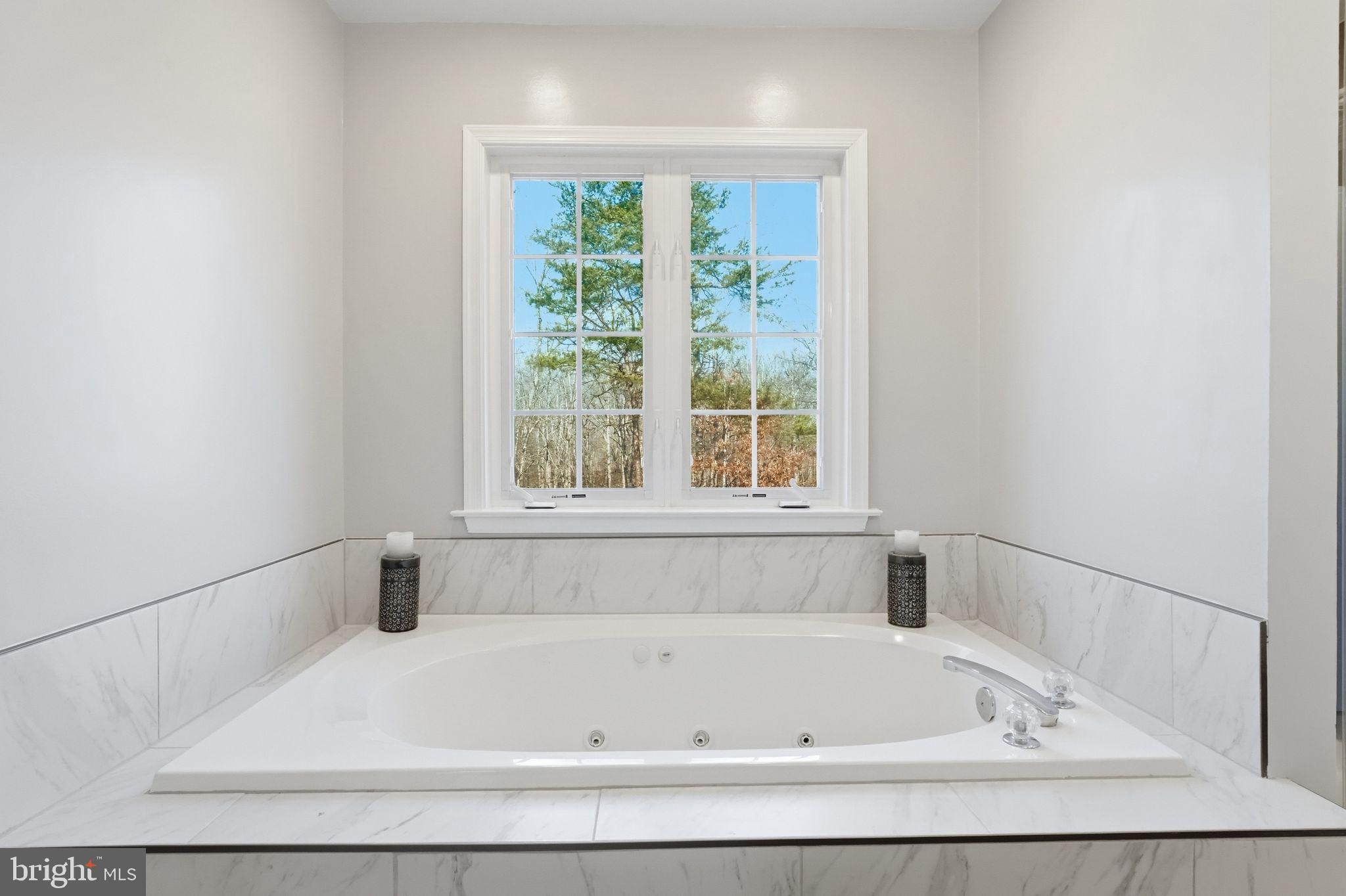 2171 Towles Road Midland, VA 22728 - Photo 31 of 58 a white bath tub sitting in a bathroom next to a window