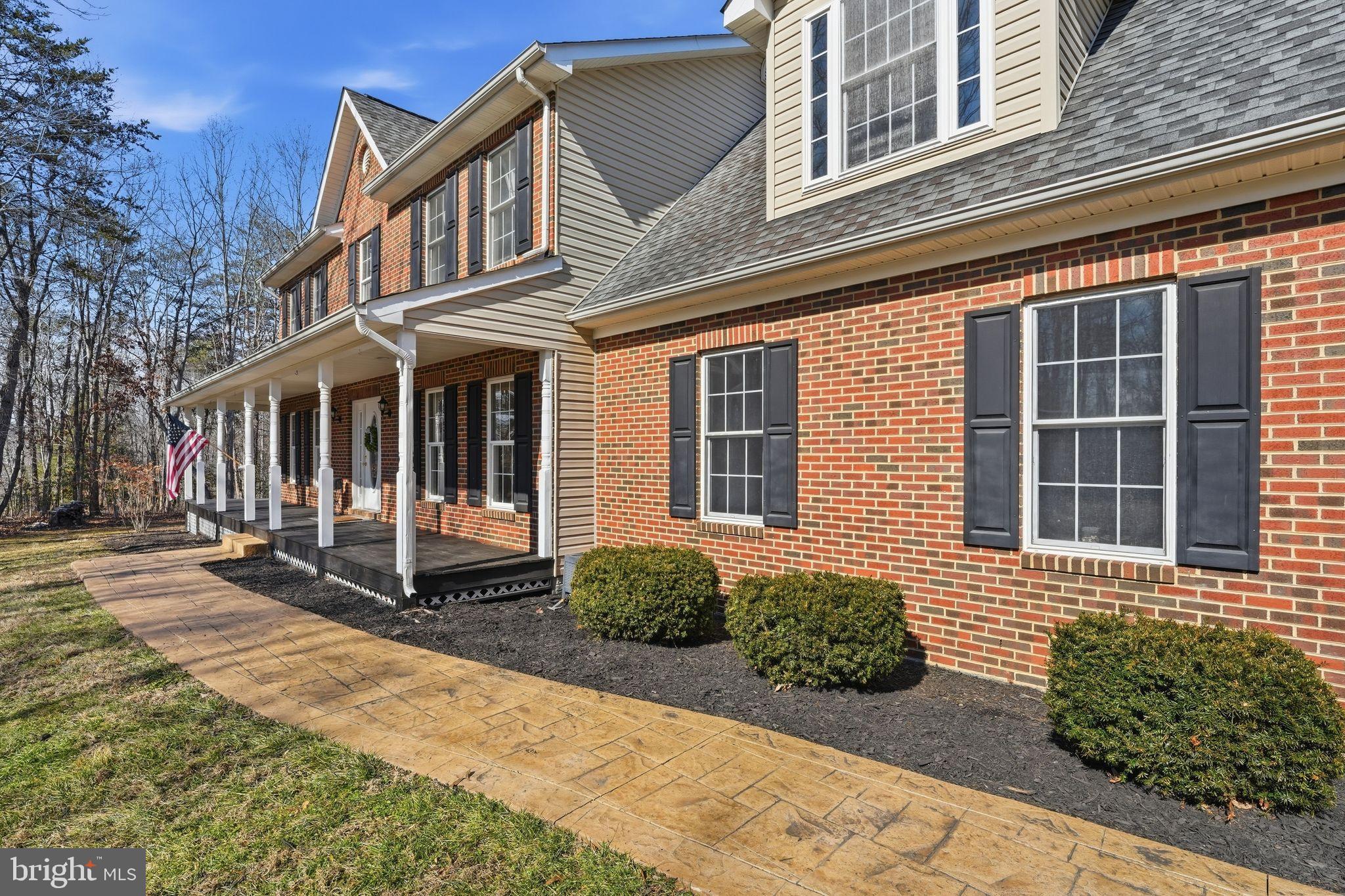 2171 Towles Road Midland, VA 22728 - Photo 4 of 58 a view of a brick house with many windows