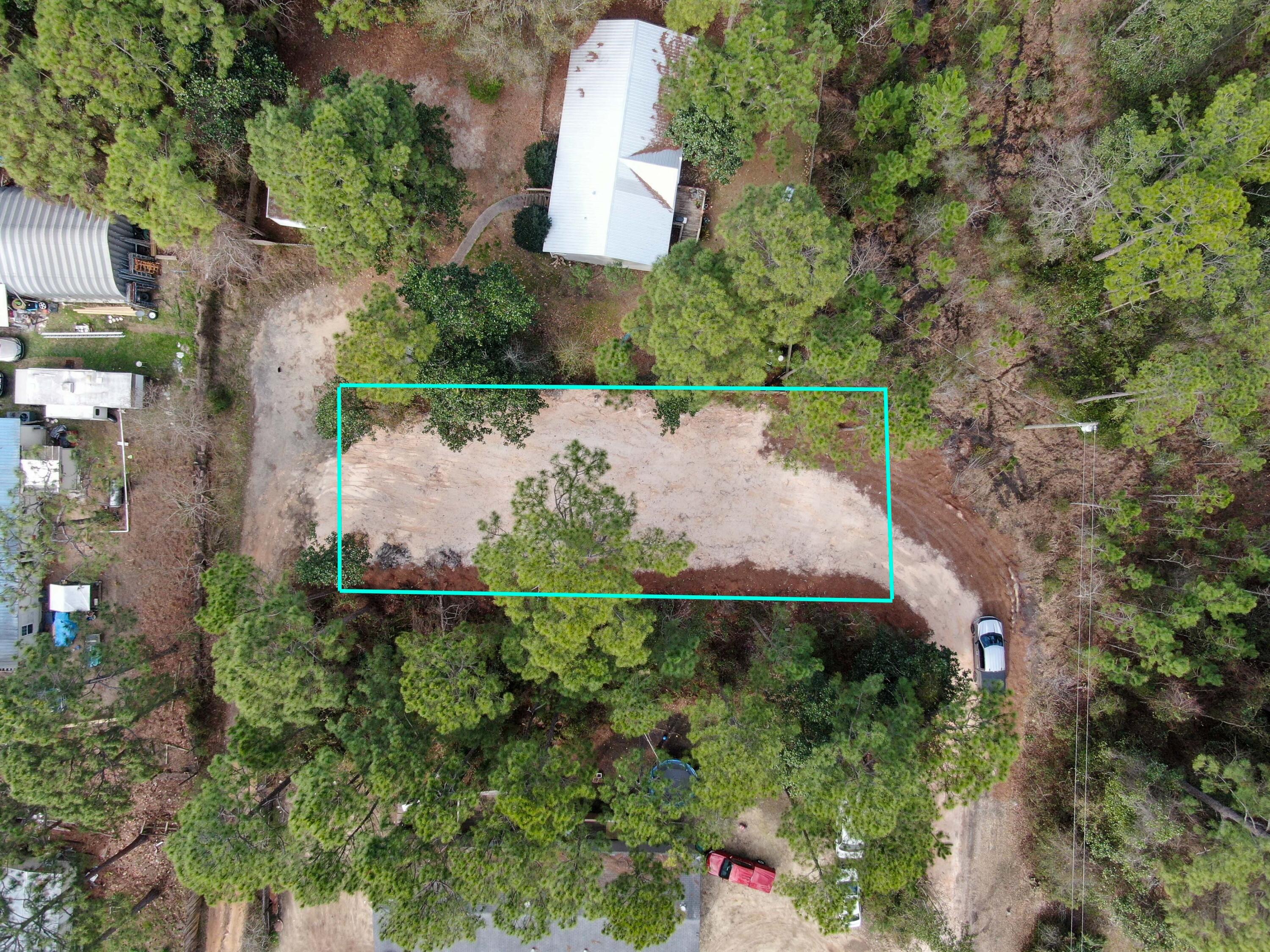 an aerial view of a house with a yard basket ball court and outdoor seating