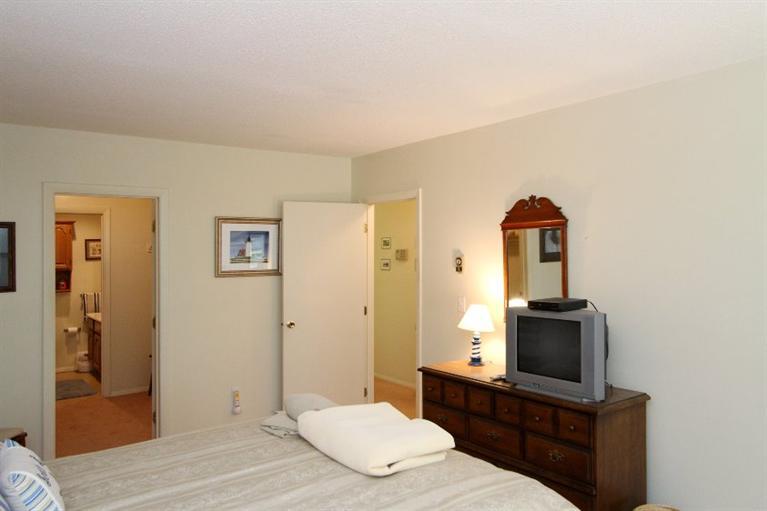 54 Round House Road, Unit 54 Bourne, MA 02532 - Photo 18 of 25 a bedroom with a bed and a flat screen tv