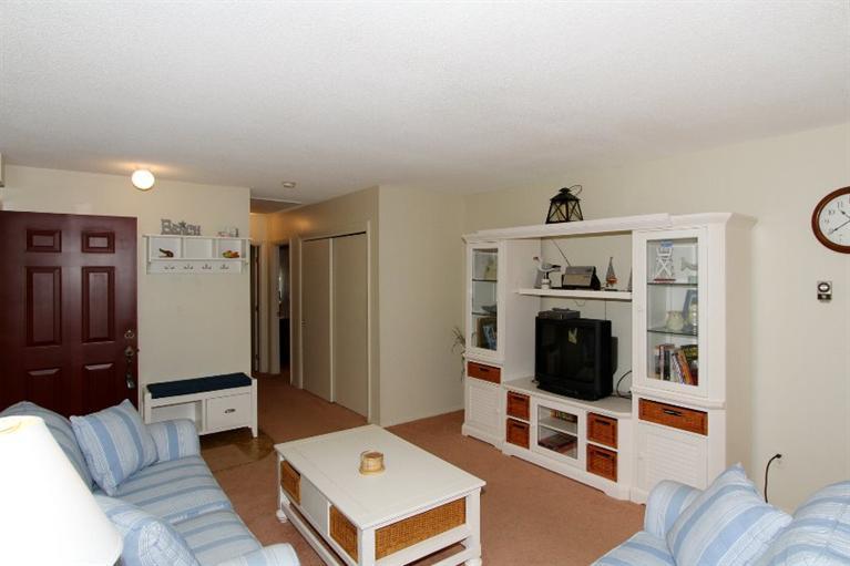 54 Round House Road, Unit 54 Bourne, MA 02532 - Photo 6 of 25 a living room with furniture and a flat screen tv