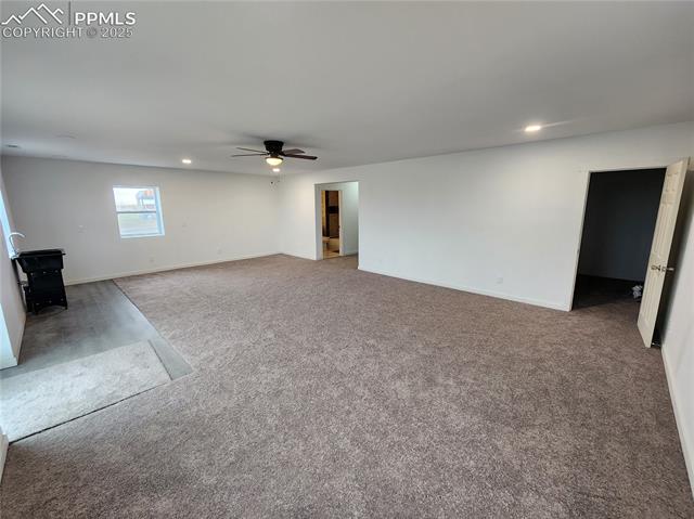 32174 Torrence Road Yoder, CO 80864 - Photo 9 of 13 Unfurnished living room with a ceiling fan, baseboards, recessed lighting, and carpet floors