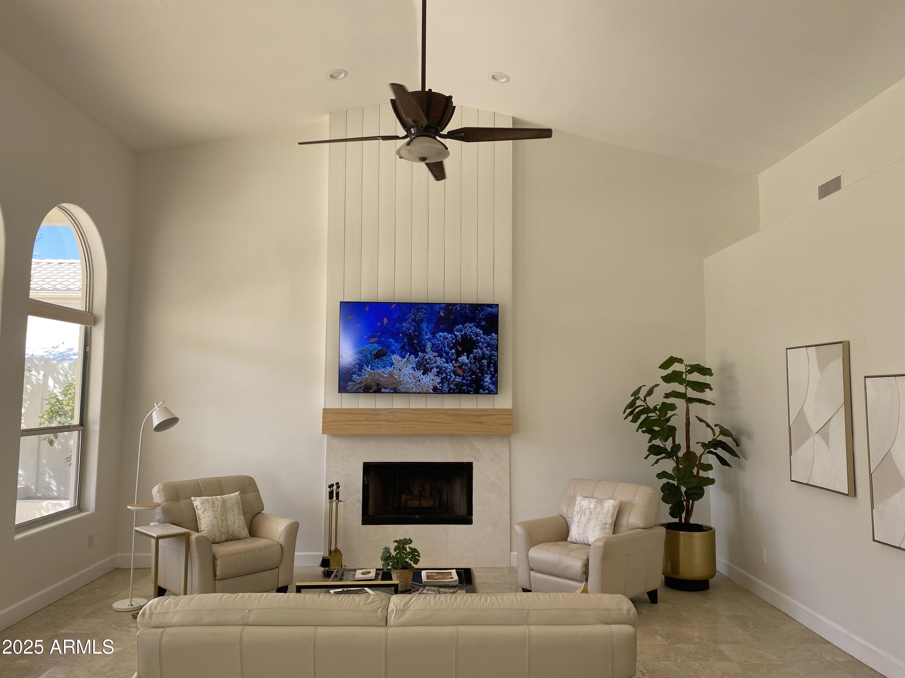 4551 East Cochise Road Phoenix, AZ 85028 - Photo 11 of 43 a living room with furniture a fireplace and a chandelier