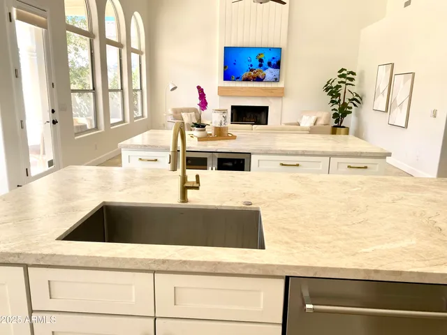 a kitchen with kitchen island a sink a stove and a white counter top space