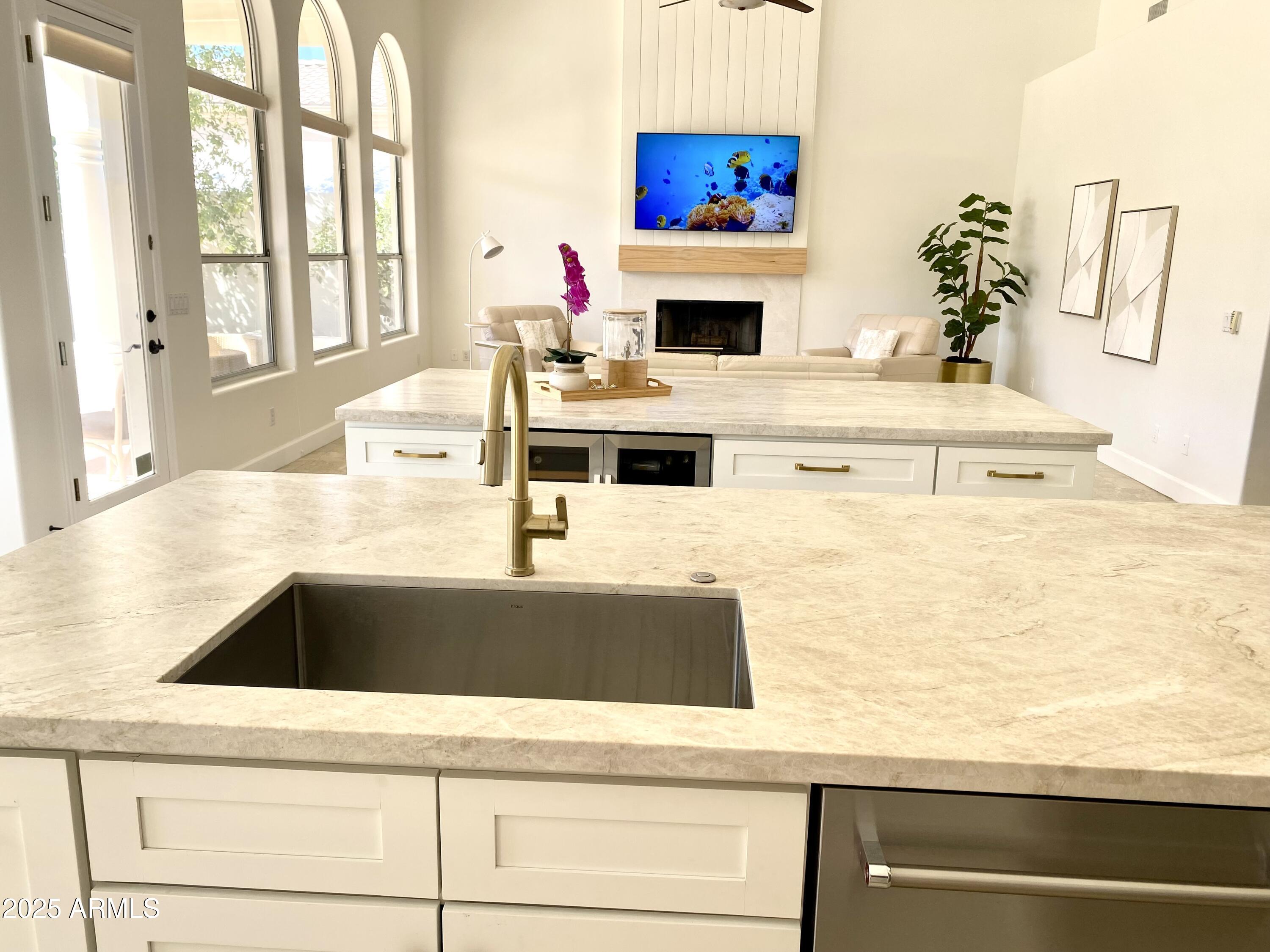 4551 East Cochise Road Phoenix, AZ 85028 - Photo 14 of 43 a kitchen with kitchen island a sink a stove and a white counter top space