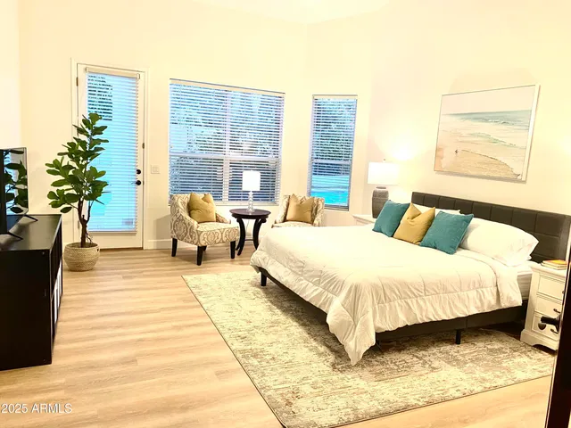 a bedroom with a large bed and a large window