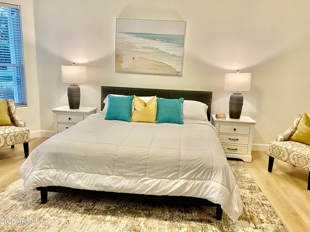 a bedroom with a bed and wooden floor