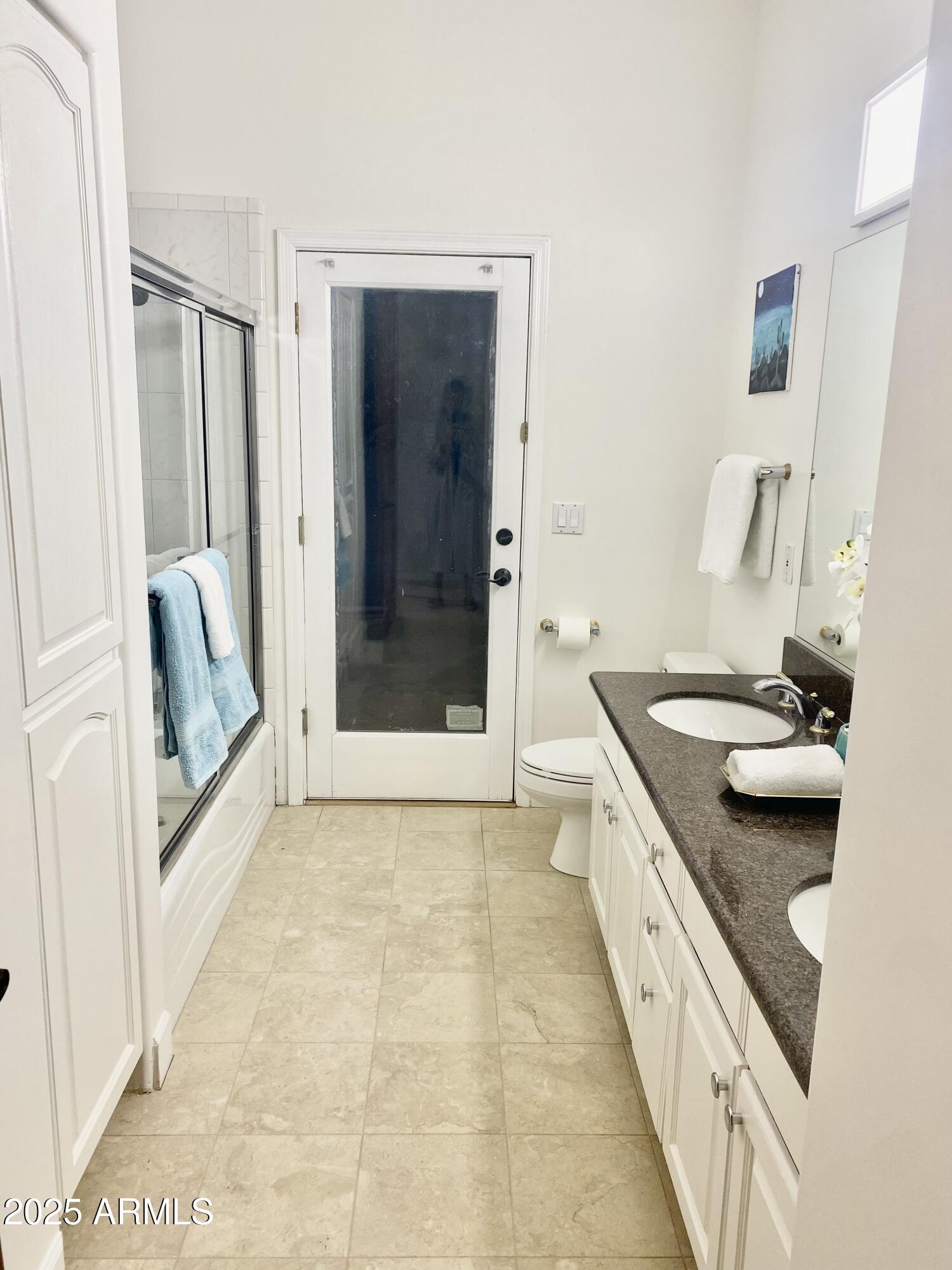 4551 East Cochise Road Phoenix, AZ 85028 - Photo 30 of 43 a bathroom with a granite countertop sink a mirror and a bathtub