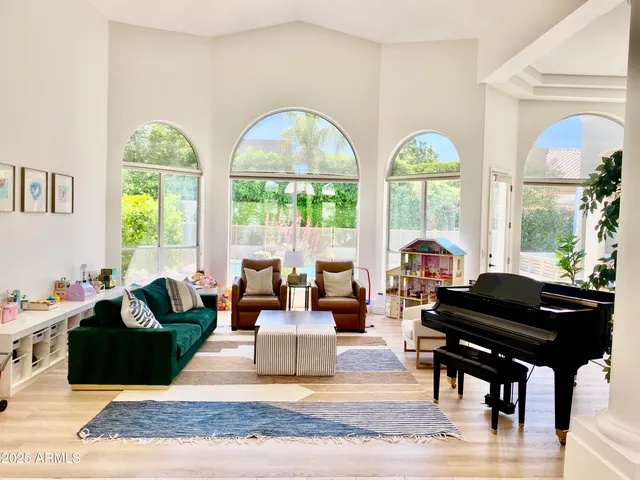 a living room with furniture fireplace and a large window
