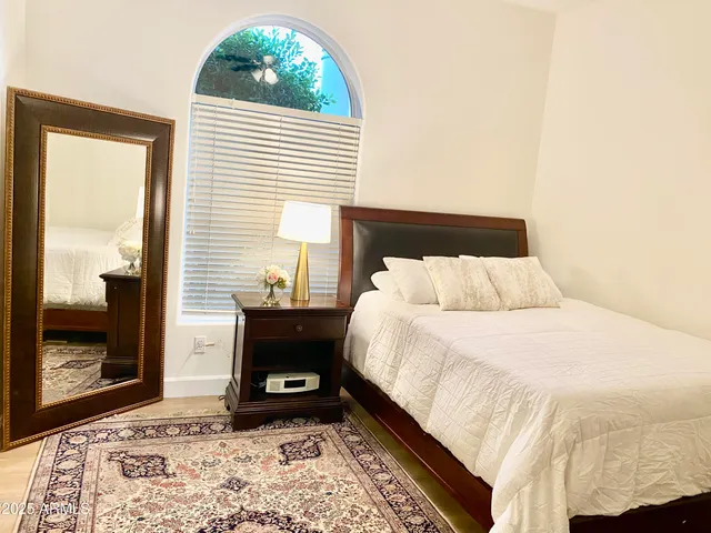 a bedroom with a bed and a window