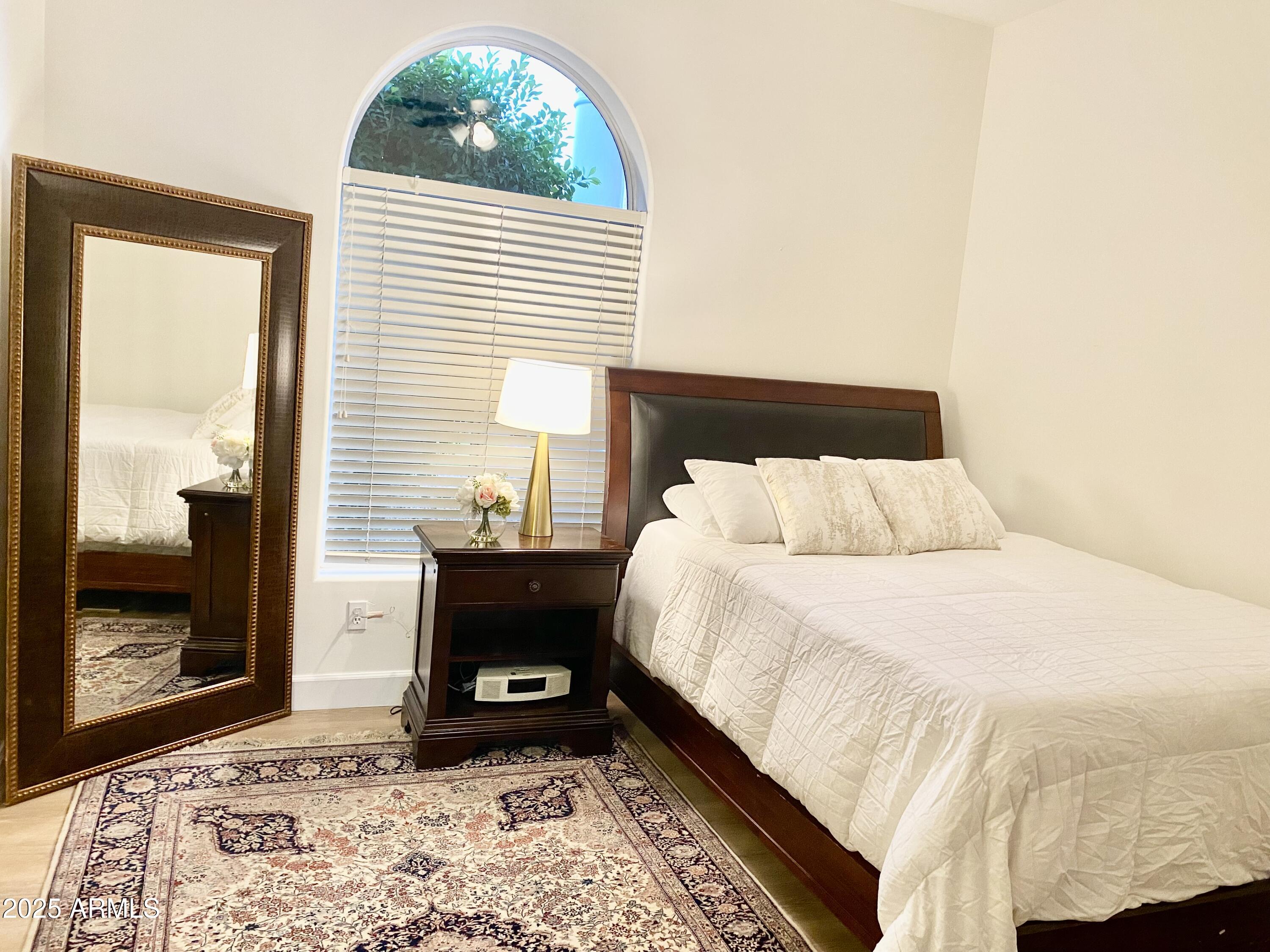 4551 East Cochise Road Phoenix, AZ 85028 - Photo 31 of 43 a bedroom with a bed and a window