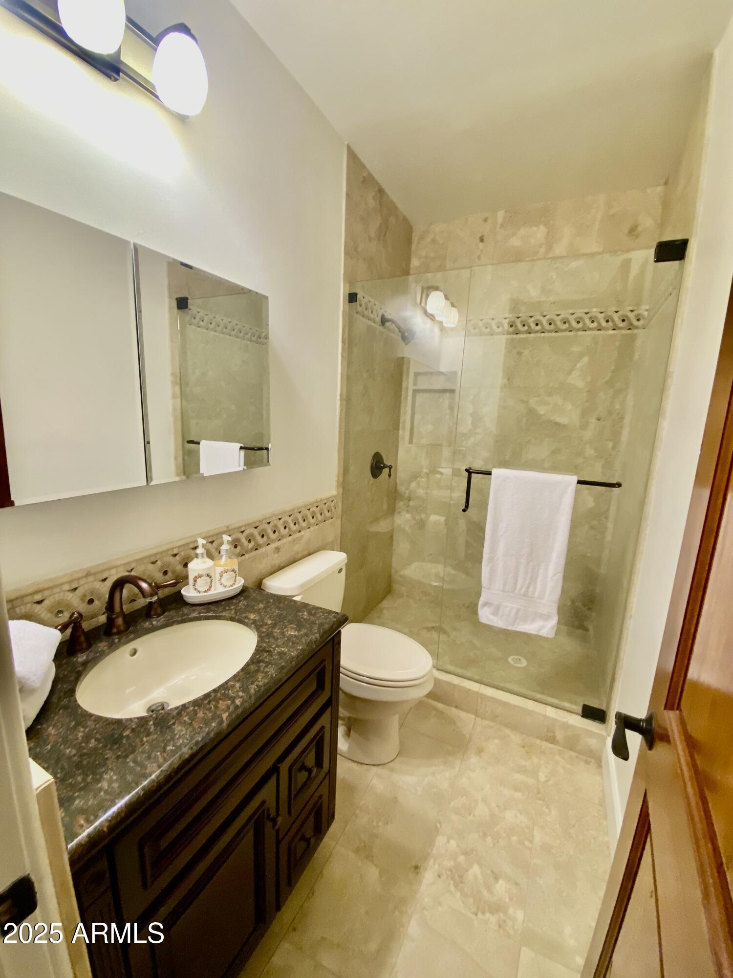 4551 East Cochise Road Phoenix, AZ 85028 - Photo 32 of 43 a bathroom with a granite countertop sink toilet and shower