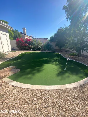 a backyard of a house with lots of green space and outdoor seating
