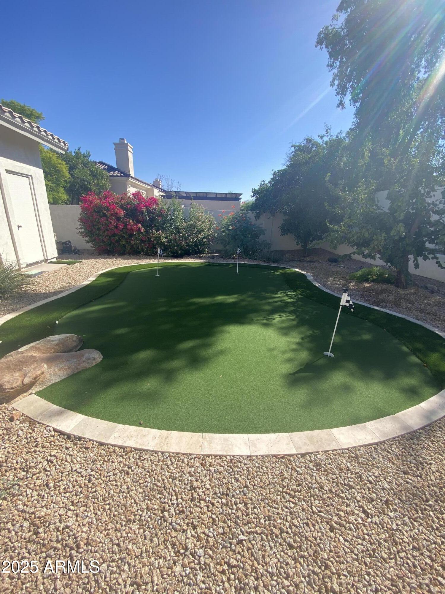 4551 East Cochise Road Phoenix, AZ 85028 - Photo 37 of 43 a backyard of a house with lots of green space and outdoor seating