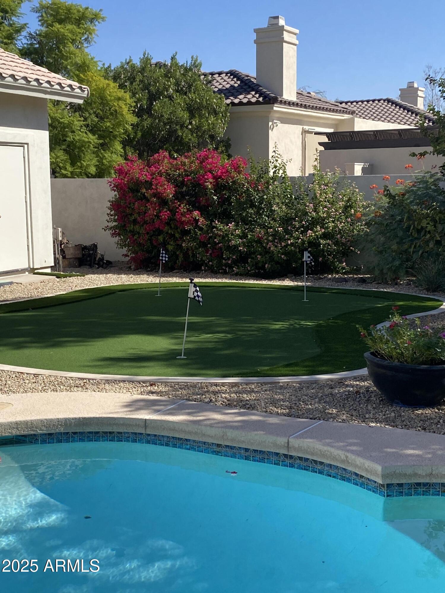 4551 East Cochise Road Phoenix, AZ 85028 - Photo 39 of 43 a view of a garden with a house