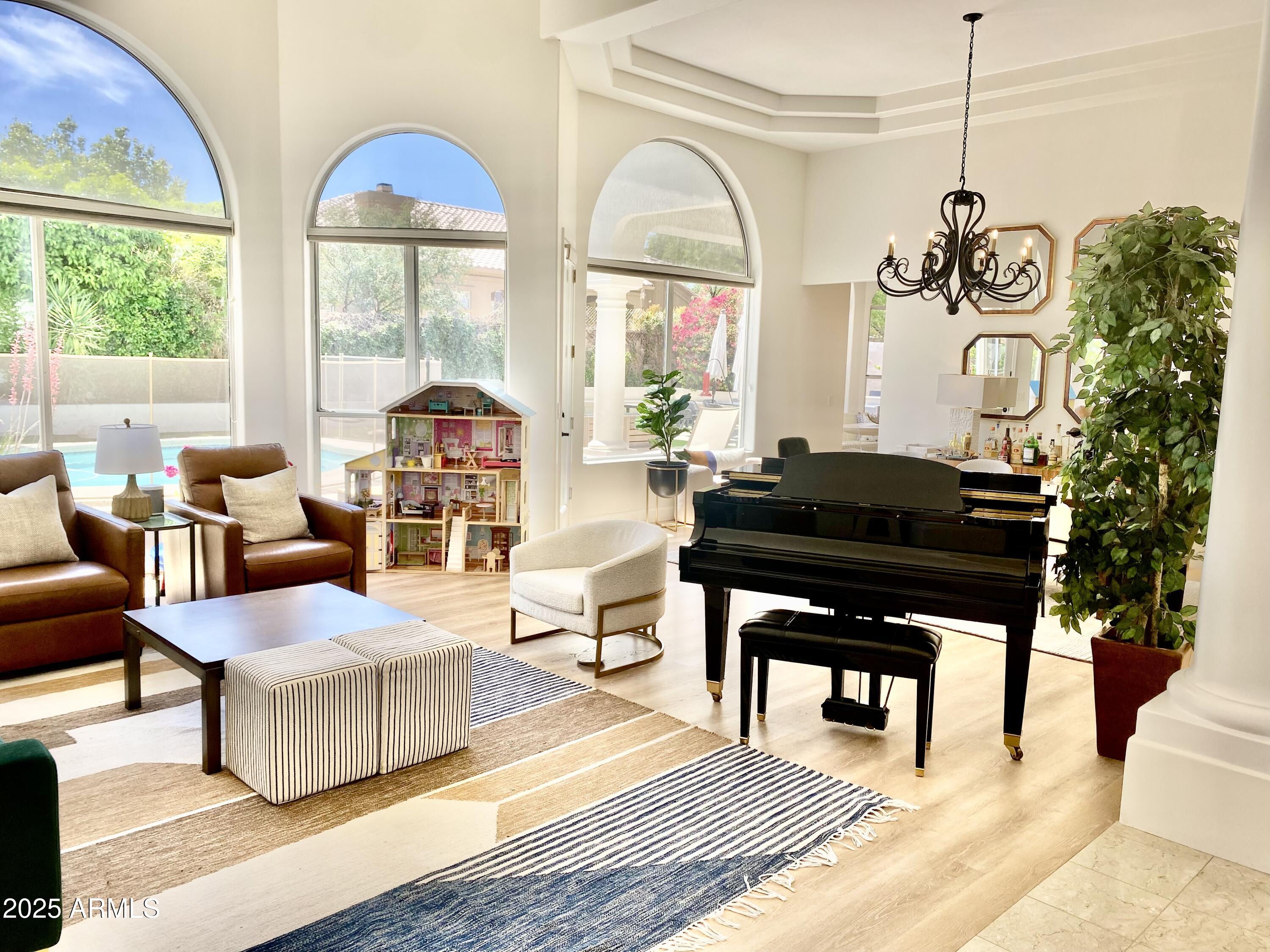 4551 East Cochise Road Phoenix, AZ 85028 - Photo 6 of 43 a living room with furniture a large window and a chandelier
