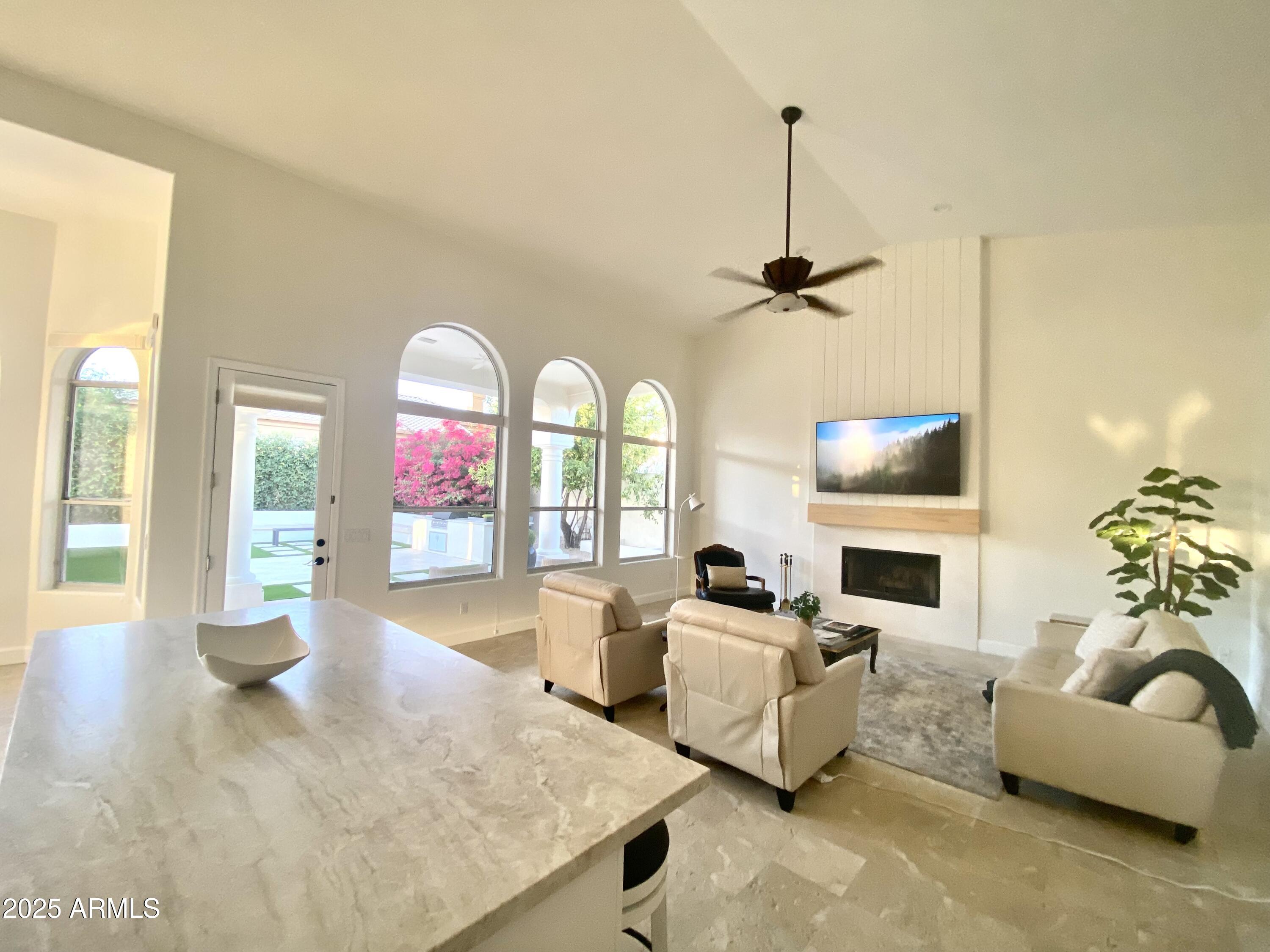 4551 East Cochise Road Phoenix, AZ 85028 - Photo 7 of 43 a living room with furniture garden view and a fireplace
