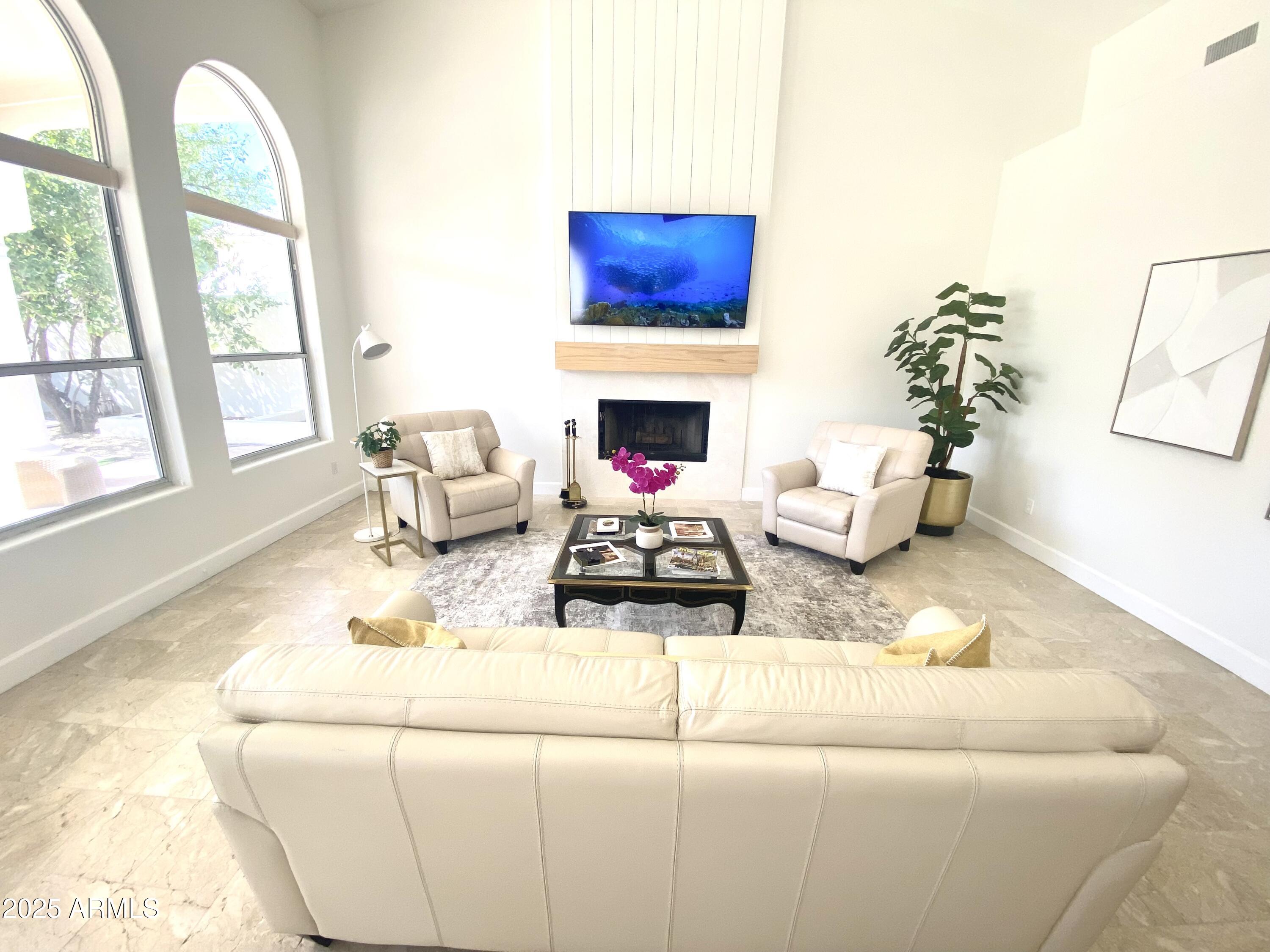 4551 East Cochise Road Phoenix, AZ 85028 - Photo 8 of 43 a living room with furniture a fireplace and potted plants