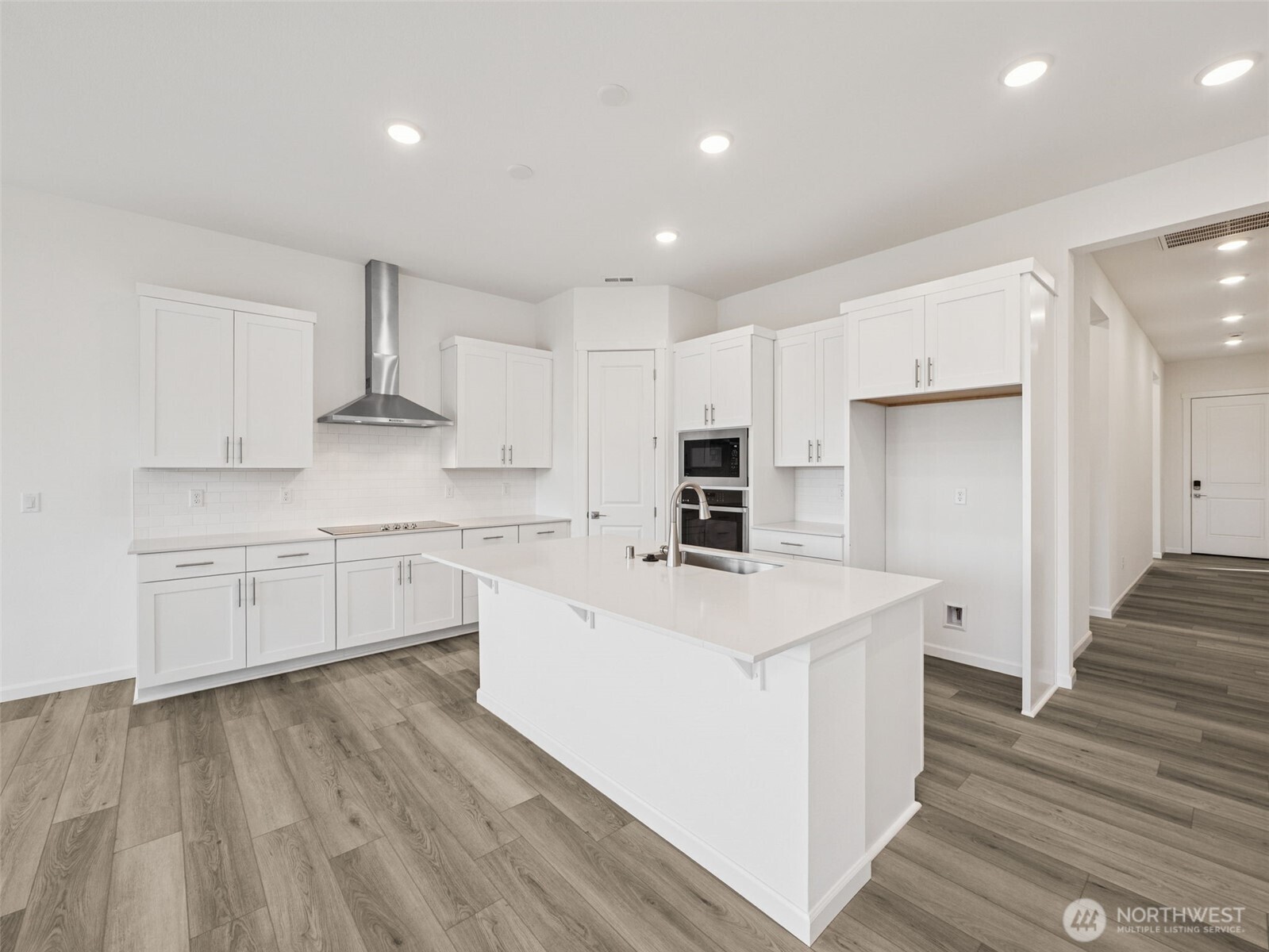 749 South Davis Street, Unit 104 Buckley, WA 98321 - Photo 3 of 11 a kitchen with stainless steel appliances a refrigerator sink and white cabinets