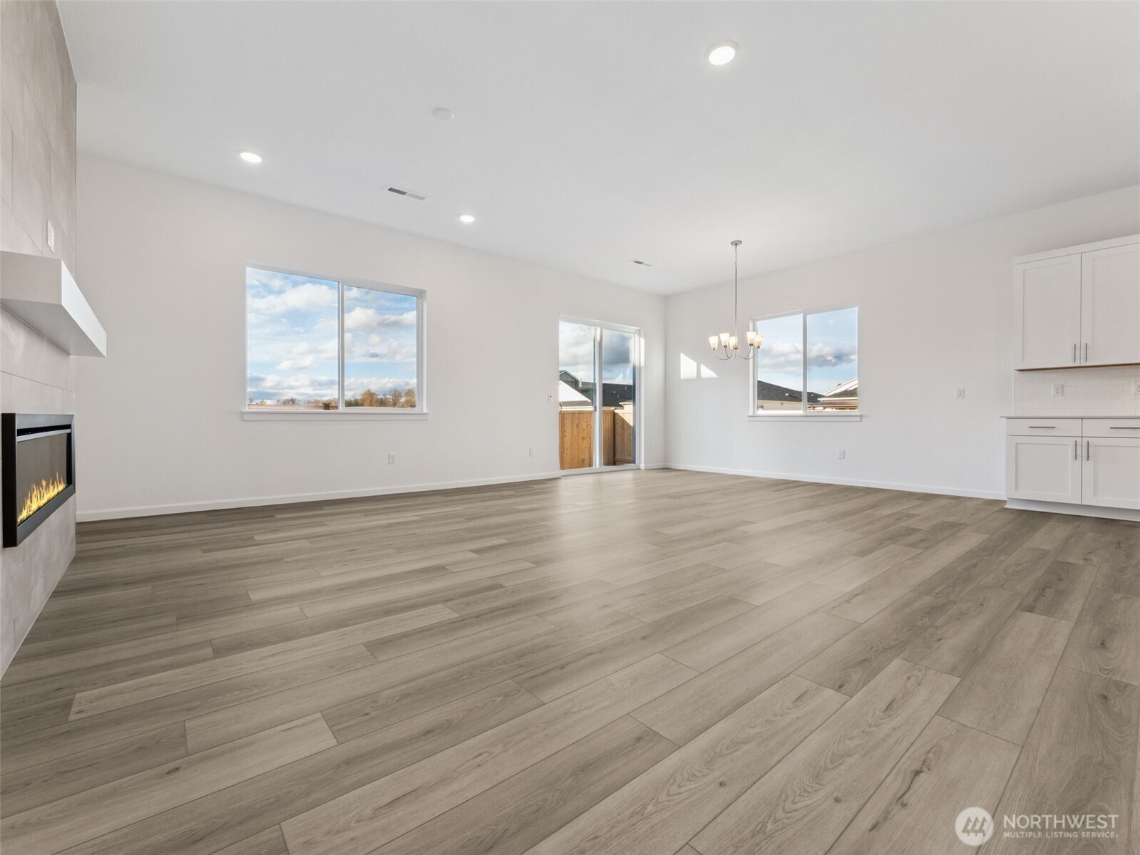 749 South Davis Street, Unit 104 Buckley, WA 98321 - Photo 6 of 11 a view of an empty room with wooden floor and a window