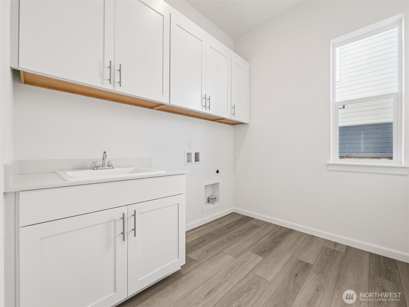 749 South Davis Street, Unit 104 Buckley, WA 98321 - Photo 9 of 11 a room with white cabinets appliances and sink