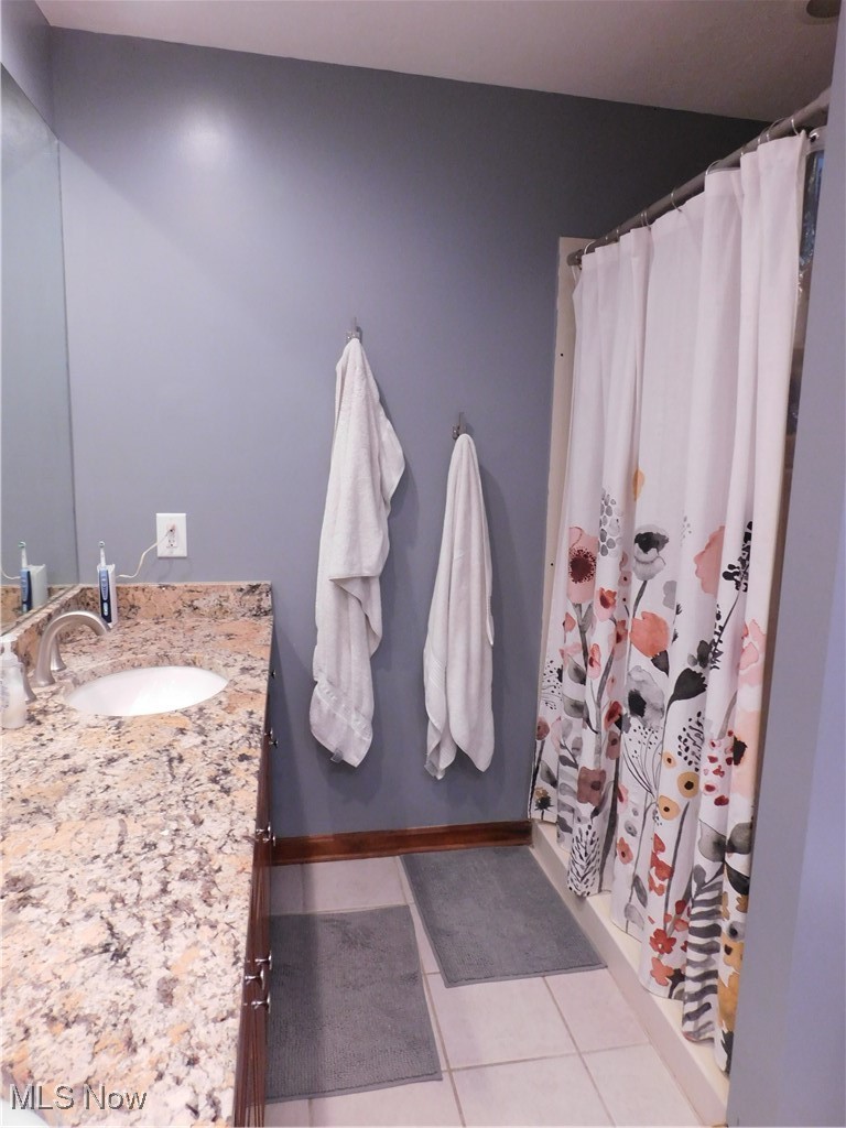 987 Hampton Ridge Drive Akron, OH 44313 - Photo 38 of 49 Bathroom with vanity, a stall shower, and light tile patterned flooring