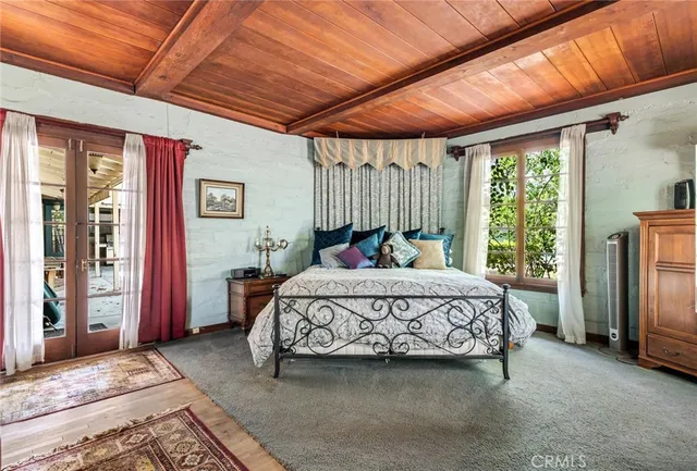 a bathroom with a sink a toilet a mirror and shower