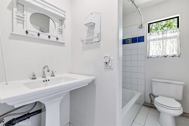 a patio with a table and chairs under an umbrella