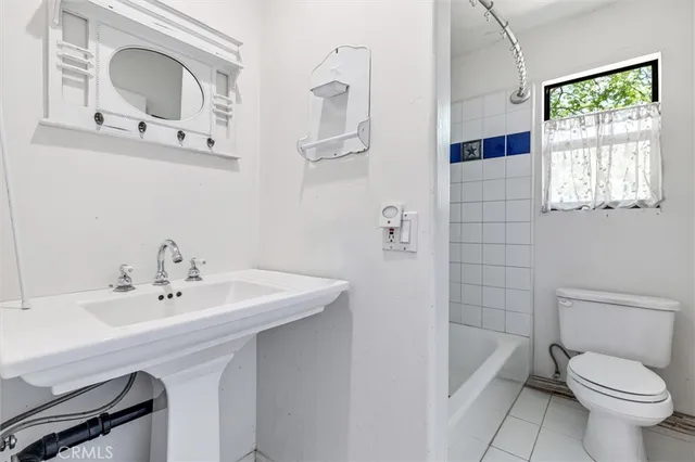 a patio with a table and chairs under an umbrella