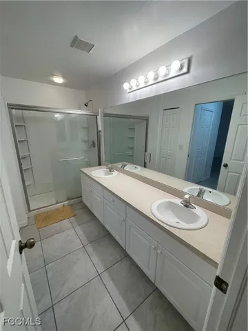 a bathroom with a sink double vanity and a mirror